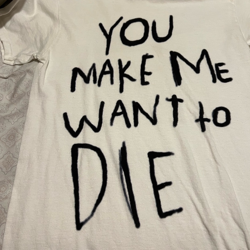 A White Graphic Tshirt With Some Text
